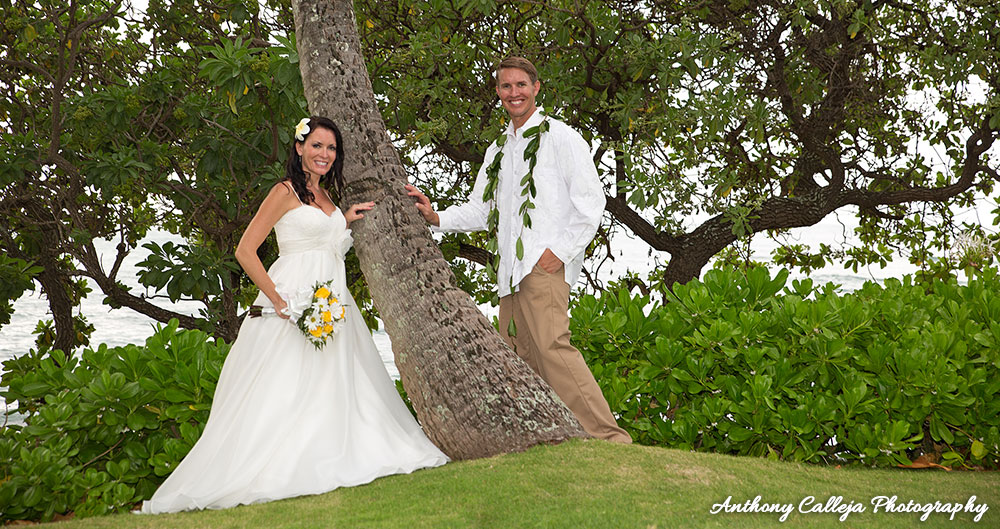 Honolulu Wedding Photography - Portrait of Bride and Groom standing near a coconut tree