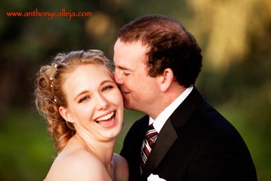 Honolulu Wedding Photographer - closeup photo of groom wispering in bride's ear making her laugh