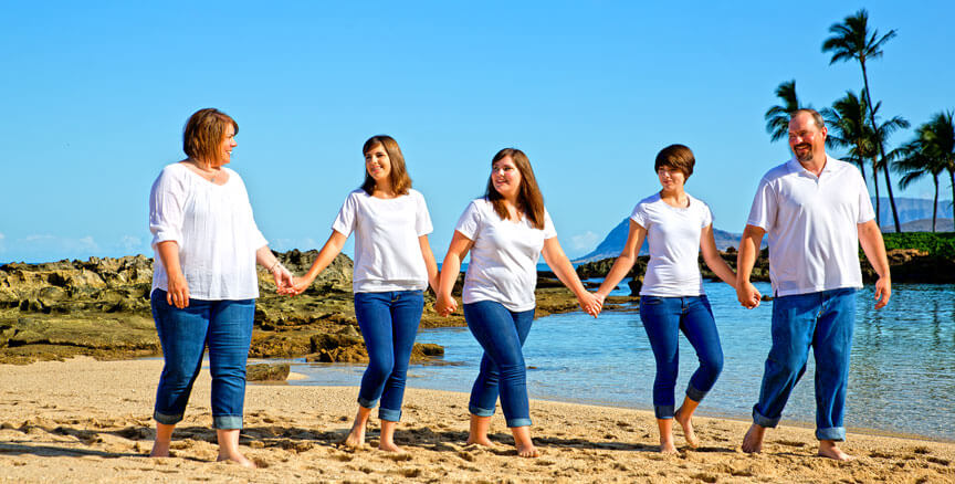 Portrait of a family of five walking on the sands of Paradise Cove Beach, KoOlina Resort, Oahu