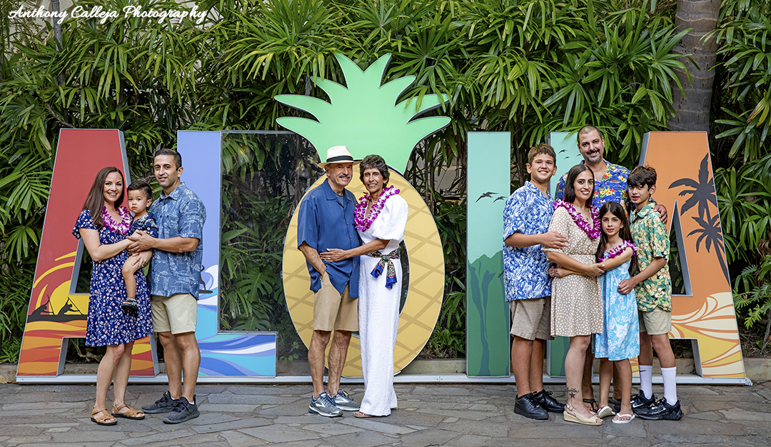 Beach family lifestyle photography - Family of four holding hands walking on the sand at Secret Beach, Koolina.