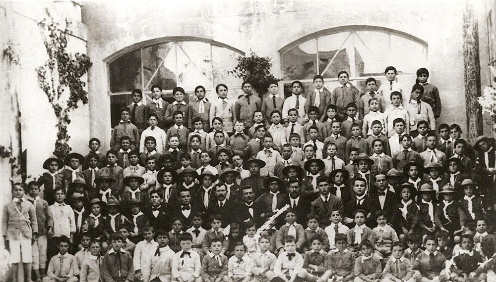 Mosta Boys School - Class Photo 1916. My Father Pacifico Calleja was 11 years old. He is in the center of the photo 3rd Row from the top. His brother Joseph Calleja who was a teacher at the school is in the 2nd row first person on the left with a black bow tie.