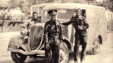 I remember back in 1972 when I first saw this photo. It was on a Sunday Evening when we had visitors, and my father made remarks about this photo and talked about the other 2 in this photo. My Dad was very smart and during the War he had 3 cars and turned them into trucks because he knew with the rationing of Gasoline only trucks and buses could have fuel and leased the 3 vehicle to the British Army. My Father was a civilian and drove for the British Military. He allowed 2 of his friends to drive his other 2 truck. My Father was the driver because the vehicle is a right hand drive. the individual on the right is George Spiteri. One of my Father’s Friends.